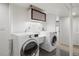 Bright laundry room with a modern washer and dryer, providing a functional space at 1400 E Bates Ave, Englewood, CO 80113