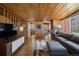 Bright living room boasting wood ceilings, stylish furnishings, fireplace and open to the kitchen at 1400 E Bates Ave, Englewood, CO 80113
