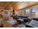 Bright living room with wood ceilings, brick fireplace, large windows, and stylish furnishings at 1400 E Bates Ave, Englewood, CO 80113