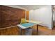 Office featuring hardwood floors, exposed brick, and a sewing table at 1400 E Bates Ave, Englewood, CO 80113