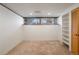 Room featuring neutral carpeting, a window, and built-in shelves at 1400 E Bates Ave, Englewood, CO 80113