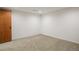 Room featuring neutral carpeting, white walls, and a wood door at 1400 E Bates Ave, Englewood, CO 80113