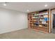Room featuring neutral carpeting and shelves stocked with supplies at 1400 E Bates Ave, Englewood, CO 80113