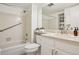 Neutral bathroom featuring a shower-tub combo, vanity and tiled walls at 8335 Fairmount Dr # 5-106, Denver, CO 80247