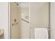 Bathroom shower featuring supportive handrails, tiled walls, and glass door at 8335 Fairmount Dr # 5-106, Denver, CO 80247