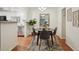 Cozy dining area featuring a round table with seating for four, adjacent to the modern kitchen at 8335 Fairmount Dr # 5-106, Denver, CO 80247