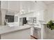 Well-lit kitchen with stainless steel appliances, white cabinets, and sleek countertops at 8335 Fairmount Dr # 5-106, Denver, CO 80247