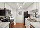 Bright, modern kitchen with stainless steel appliances, white cabinetry, and stylish countertops at 8335 Fairmount Dr # 5-106, Denver, CO 80247