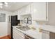 Bright kitchen featuring white cabinetry, marble countertops, stainless steel appliances and modern finishes at 8335 Fairmount Dr # 5-106, Denver, CO 80247