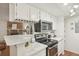 Modern kitchen with stone countertops, stainless steel appliances and decor at 8335 Fairmount Dr # 5-106, Denver, CO 80247