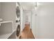 Hallway laundry area with stacked washer and dryer unit and storage at 8335 Fairmount Dr # 5-106, Denver, CO 80247