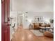 Bright living room view from the entryway, showcasing the modern decor and open layout at 8335 Fairmount Dr # 5-106, Denver, CO 80247