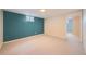 Finished basement with carpeting, neutral walls and a small window that provides natural light at 7700 E Oxford Ave, Denver, CO 80237