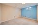 Basement area with carpet and light blue accent wall at 7700 E Oxford Ave, Denver, CO 80237