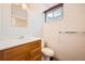 Bathroom with a wood vanity, mirror, and neutral walls at 7700 E Oxford Ave, Denver, CO 80237
