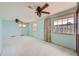 Spacious bedroom with three windows, a ceiling fan and wall-to-wall carpeting at 7700 E Oxford Ave, Denver, CO 80237