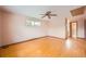 Bright bedroom with hardwood floors, light walls, a window and a ceiling fan at 7700 E Oxford Ave, Denver, CO 80237