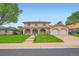 Inviting two-story home with a charming facade, arched entryway, lush lawn, and a two-car garage at 7700 E Oxford Ave, Denver, CO 80237