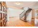 Bright foyer featuring hardwood floors, a staircase with wooden railings, and natural light at 7700 E Oxford Ave, Denver, CO 80237