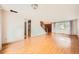 Open living space with hardwood floors, a staircase, and a large window with natural lighting at 7700 E Oxford Ave, Denver, CO 80237