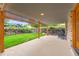 Covered back patio for outdoor entertaining with an adjacent lawn at 7700 E Oxford Ave, Denver, CO 80237