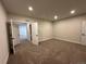 Spacious basement bedroom with plush carpeting and multiple doors at 5503 Riverbend Ave, Firestone, CO 80504