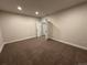 Bright basement bedroom with plush carpeting and access to other rooms at 5503 Riverbend Ave, Firestone, CO 80504