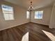 Bright dining room features hardwood floors and a modern chandelier at 5503 Riverbend Ave, Firestone, CO 80504