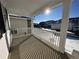 Covered front porch with white railing and view of the street at 5503 Riverbend Ave, Firestone, CO 80504