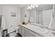 Bright bathroom features a white vanity, toilet, and shower with nice accents and decor at 2464 Garganey Dr, Castle Rock, CO 80104