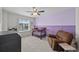 Bedroom featuring a crib, chair, and side table with views to the outside at 2464 Garganey Dr, Castle Rock, CO 80104