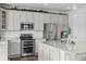 Kitchen area with stainless steel appliances, and white cabinets at 2464 Garganey Dr, Castle Rock, CO 80104