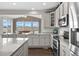 Bright kitchen featuring stone countertops, stainless appliances and hardwood floors at 2464 Garganey Dr, Castle Rock, CO 80104