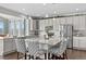 Kitchen featuring granite countertops, stainless steel appliances, and gray patterned chairs at 2464 Garganey Dr, Castle Rock, CO 80104