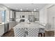 Spacious kitchen featuring gray cabinets, stainless steel appliances, and a large granite island at 2464 Garganey Dr, Castle Rock, CO 80104