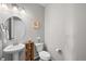 Stylish powder room with a pedestal sink and a decorative mirror at 2464 Garganey Dr, Castle Rock, CO 80104