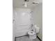 Full bath features a shower and tub with a toilet and tiled floors at 7665 E Eastman Ave # 104A, Denver, CO 80231