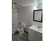 A full bathroom featuring a shower/tub combo, toilet, tile flooring, and single sink vanity with a mirror at 7665 E Eastman Ave # 104A, Denver, CO 80231