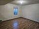 This bedroom features wood flooring and a window that allows for natural light at 7665 E Eastman Ave # 104A, Denver, CO 80231