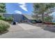 View of the rear of the building featuring a concrete driveway, foliage, and steps to the tennis court at 7665 E Eastman Ave # 104A, Denver, CO 80231