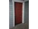 A close-up of the front door with a red door and a white trim, and the number 104 above it at 7665 E Eastman Ave # 104A, Denver, CO 80231