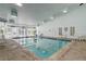 A bright indoor pool area has multiple tables and chairs and access to an outdoor patio at 7665 E Eastman Ave # 104A, Denver, CO 80231