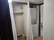 Laundry closet with stacked washer and dryer and white curtain at 7665 E Eastman Ave # 104A, Denver, CO 80231