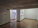 Open living area with wood floors transitions to kitchen, showcasing layout and flow at 7665 E Eastman Ave # 104A, Denver, CO 80231