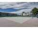 Exterior view of a tennis court surrounded by lush landscaping and modern architecture at 7665 E Eastman Ave # 104A, Denver, CO 80231