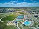 An aerial view of neighborhood amenities, including a pool, playground, and sports courts at 14337 Shasta Daisy Pt, Parker, CO 80134
