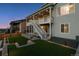 Well maintained backyard with a lush lawn, retaining wall, a two-level deck and outdoor lighting at 14337 Shasta Daisy Pt, Parker, CO 80134
