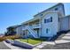 Well-maintained backyard with artificial turf, hardscaping, and steps leading to the upper level and views of neighborhood at 14337 Shasta Daisy Pt, Parker, CO 80134