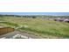 Beautiful backyard view of lush green fields and neighboring houses, framed by a wood fence at 14337 Shasta Daisy Pt, Parker, CO 80134