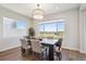 Dining room with a dark wood table set under a modern light fixture and large view window at 14337 Shasta Daisy Pt, Parker, CO 80134